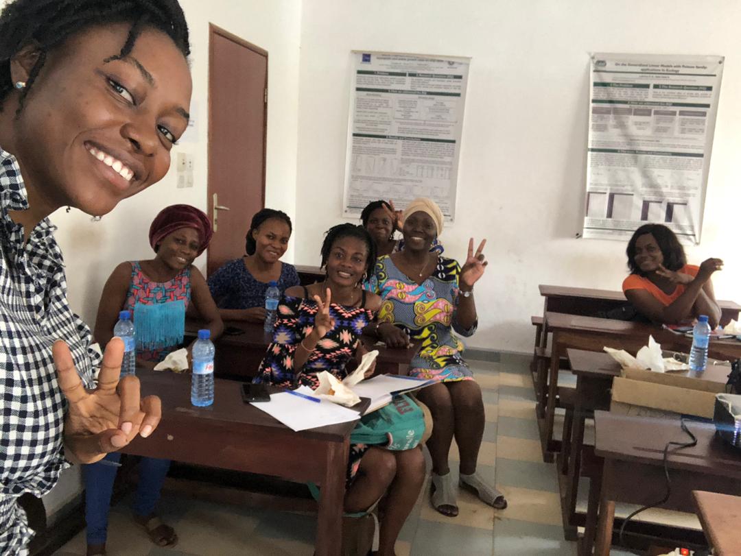 Happy members of R-Ladies Cotonou sharing some pastries. This picture was taken on the first official meetup where the members learned everything useful about R-Ladies and especially on R-Ladies Cotonou.